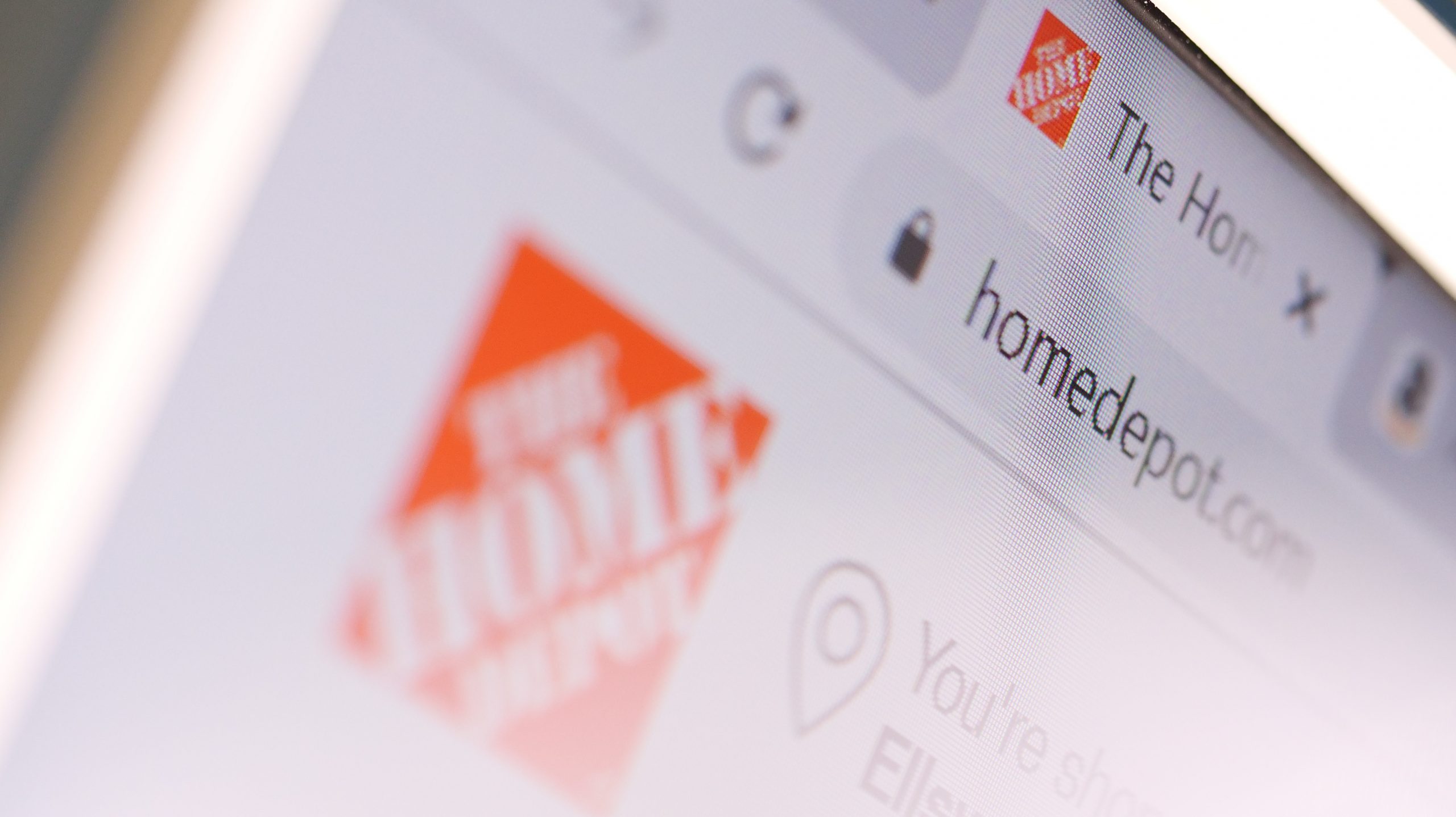 The Home Depot domain name in browser and logo on the computer screen.