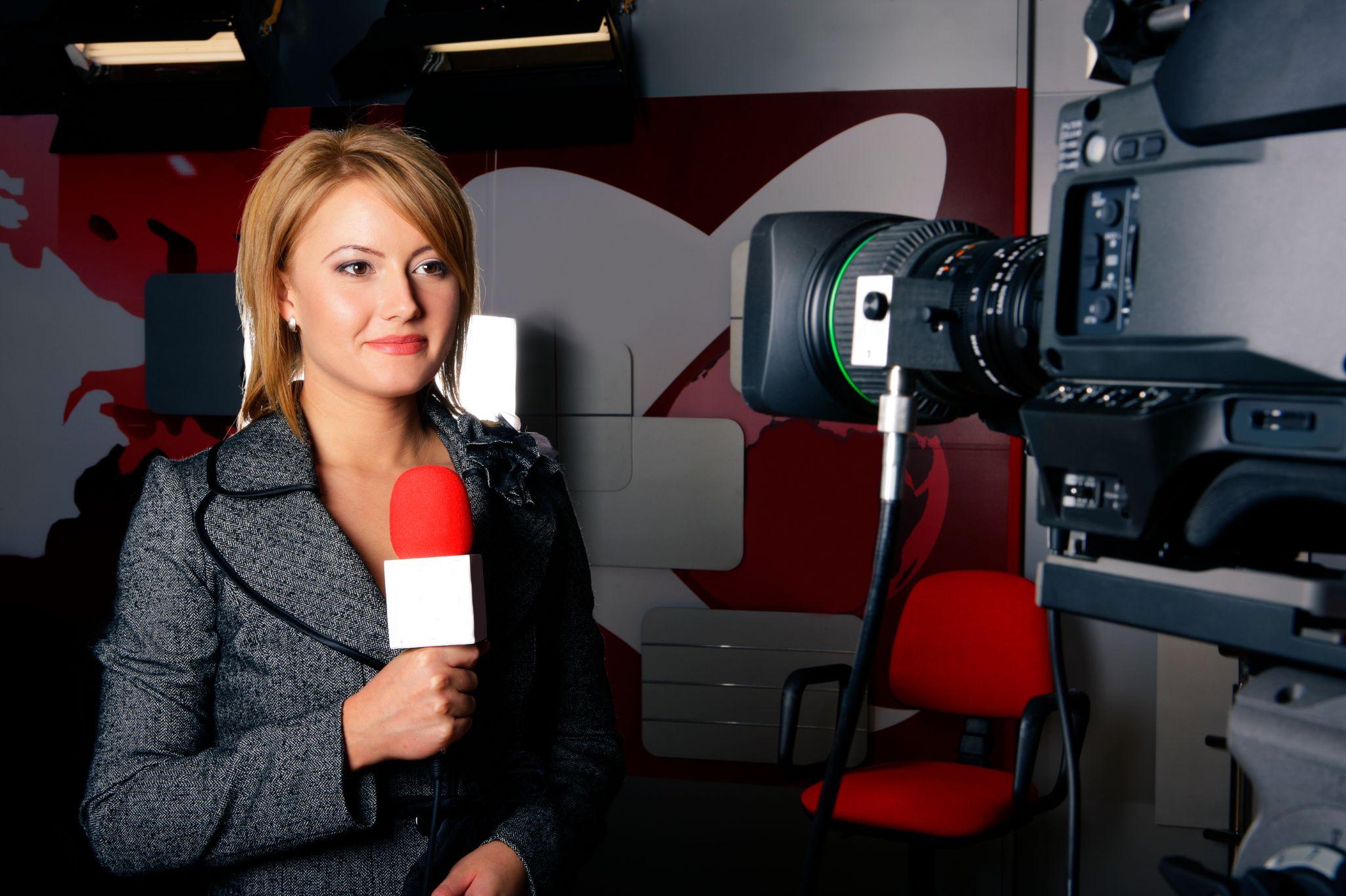 female journalist in front of a camera