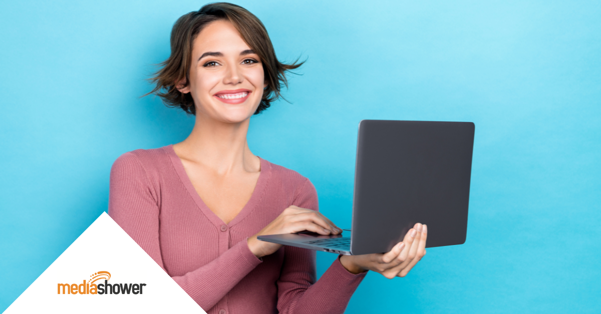 young woman holding a laptop