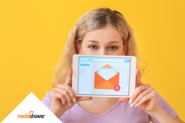 girl holding a tablet with an email marketing template