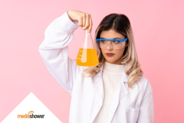 girl in a lab coat holding a erlenmeyer flask 