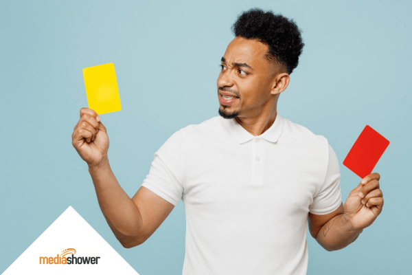man holding a yellow and a red card