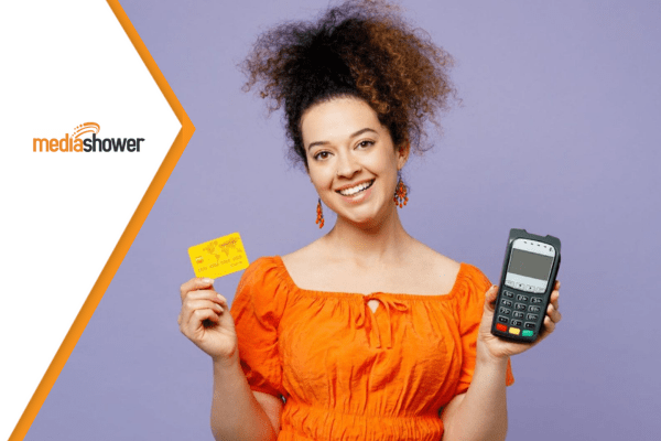 woman holding a credit card and a POS