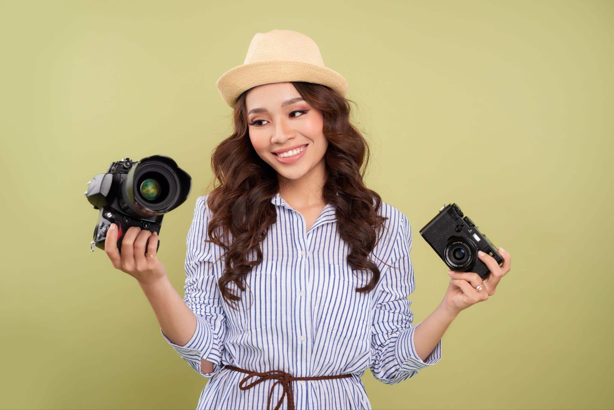 woman holding two cameras
