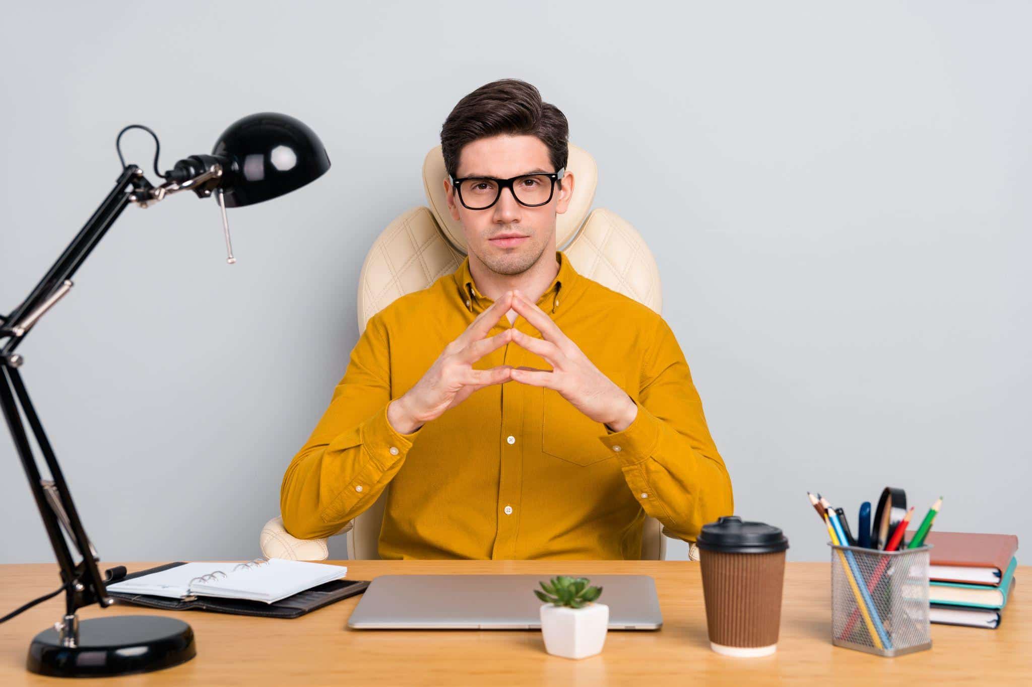 young man sitting at his work desk ready for an SME interview