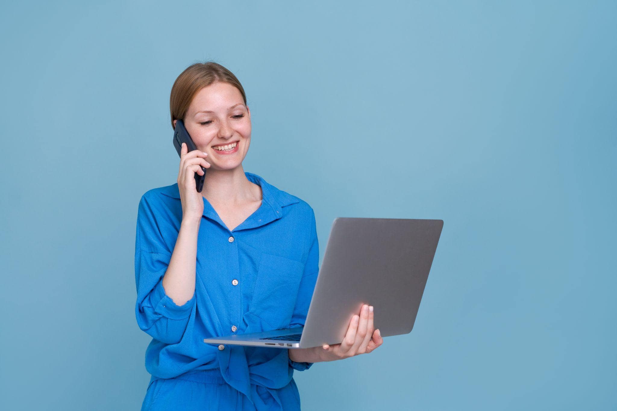 woman holding a laptop working on a promotional campaign generator