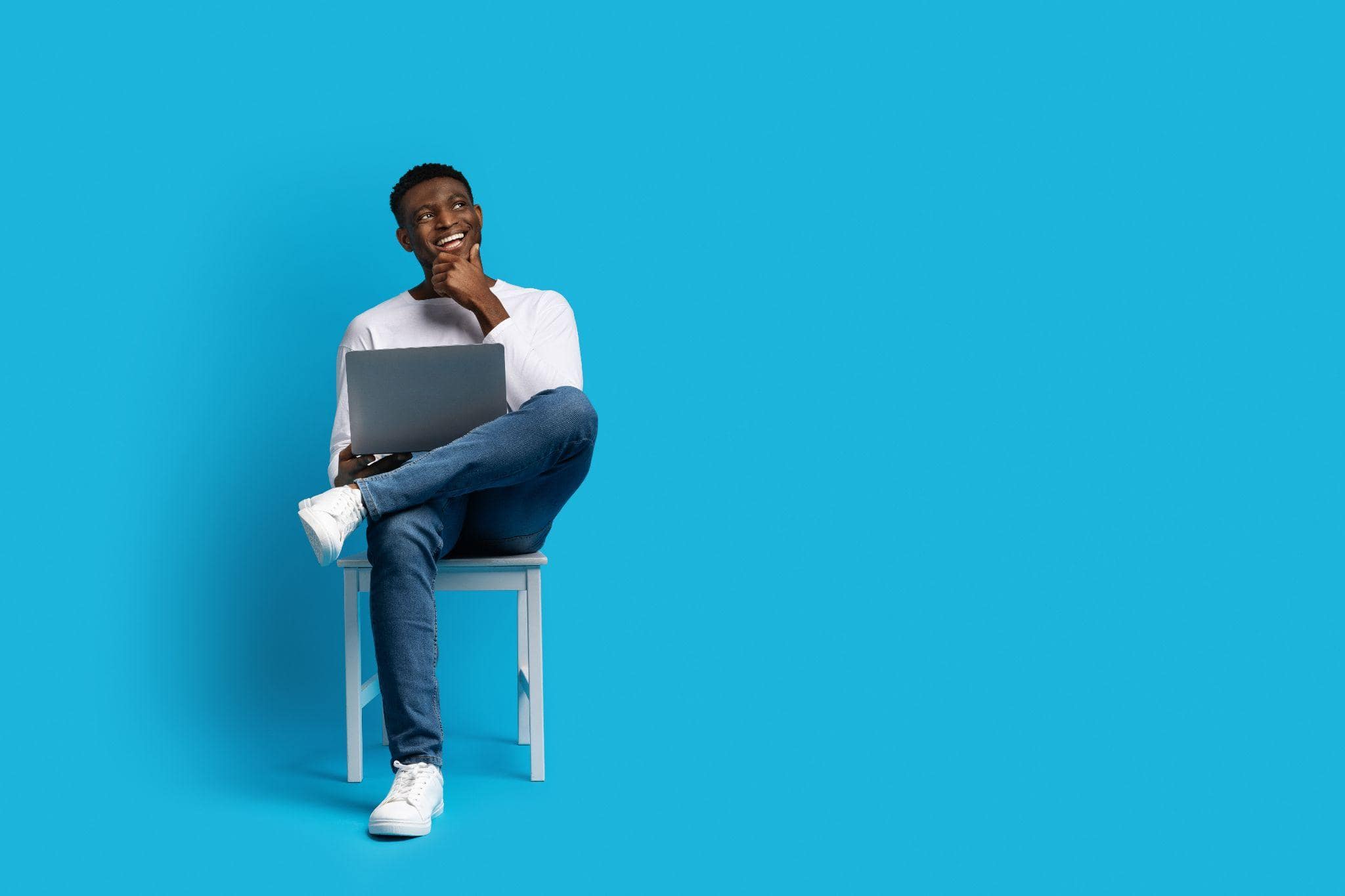 happy young man sitting and working on his content calendar