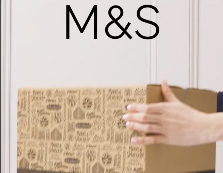 holding a box with M&S logo