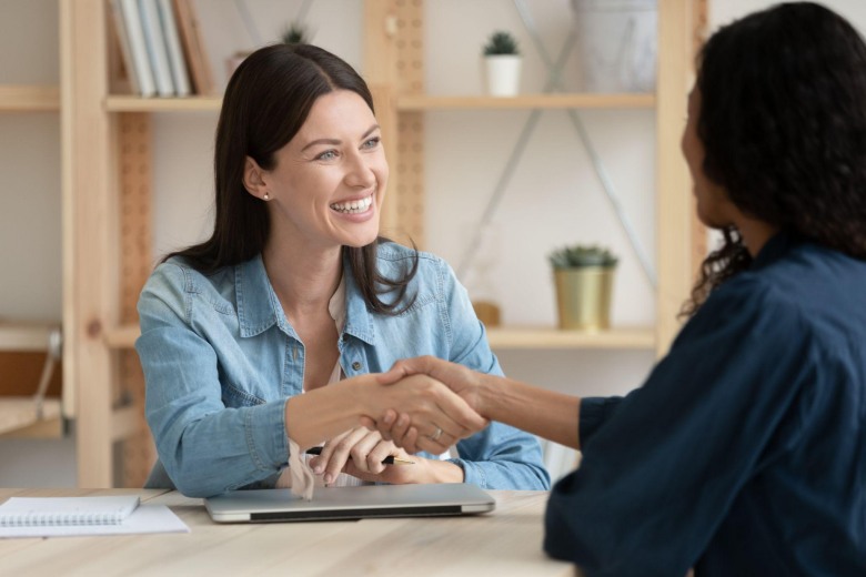 smiling woman shaking hands during an AI interview prep session