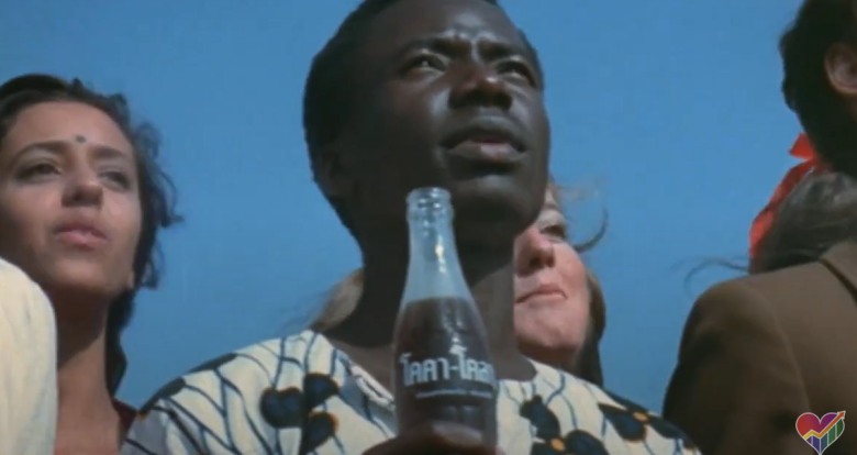 young black man holding a coca cola bottle in commercial