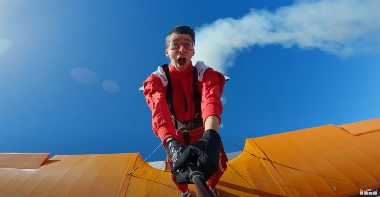 young man paragliding and recording on his gopro