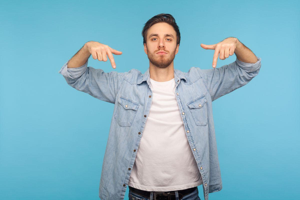 young man pointing downwards