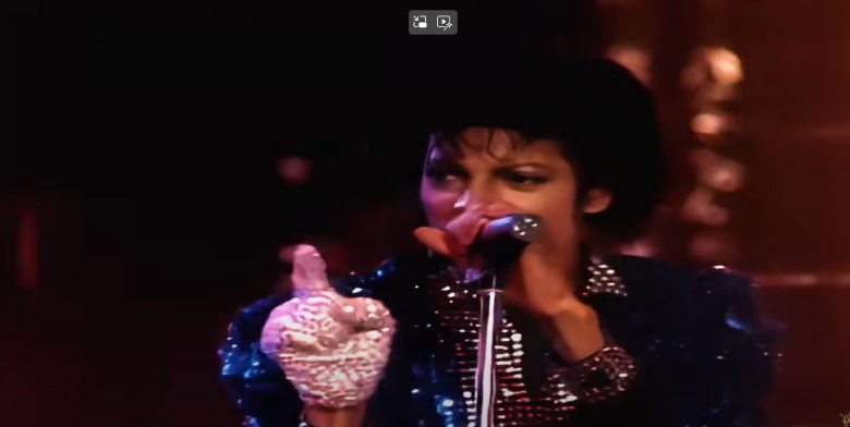 michael jackson holding the mic while performing on stage