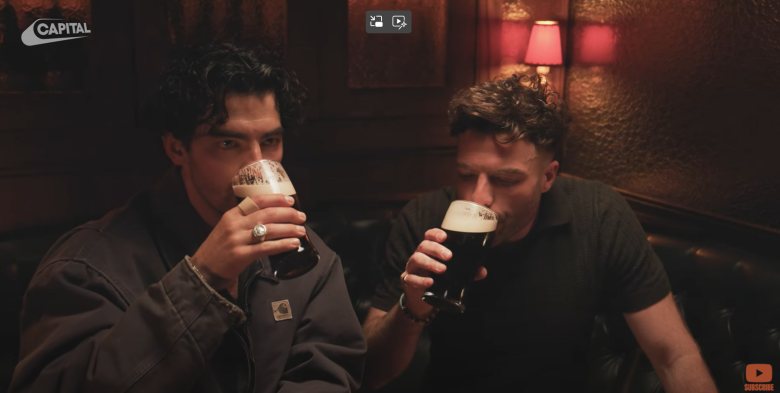 two young men enjoying a pint of Guinness in a pub