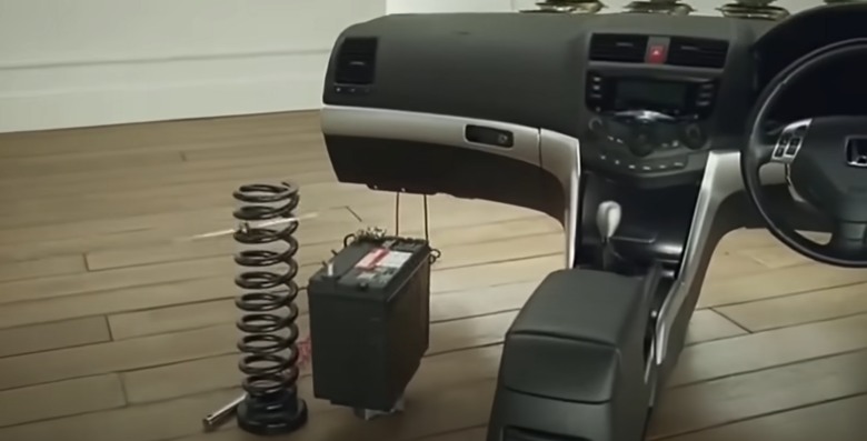 car dashboard and a big spring inside a house from a Honda ad