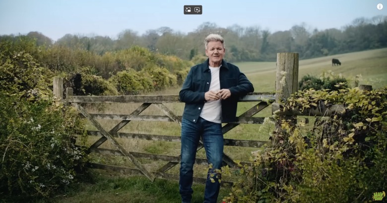 gordon ramsay leaning on a rustic wooden gate