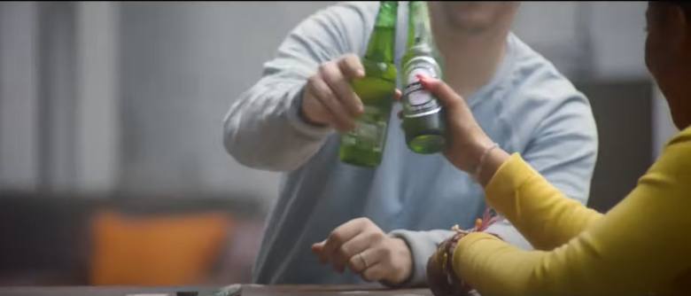 two people having a bottle of beer