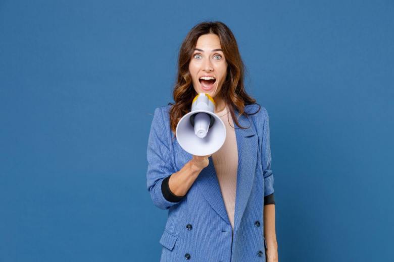 happy woman talking in a megaphone