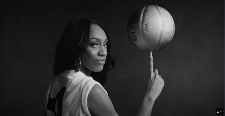 female basketball player balancing a basketball on her finger