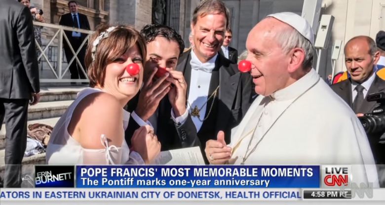 pope Francis laughing with a married couple