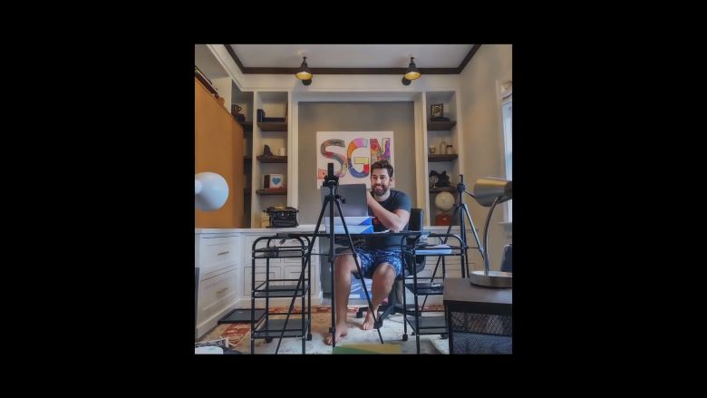 John Krasinki using a macbook at a desk