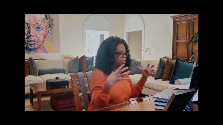 Oprah sitting at a table on a FaceTime videocall as part of Apple's campaign