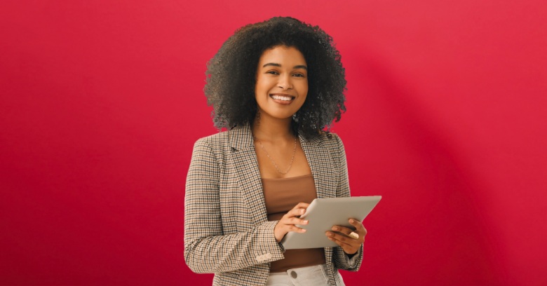 black woman in a paid blazer holding a tablet