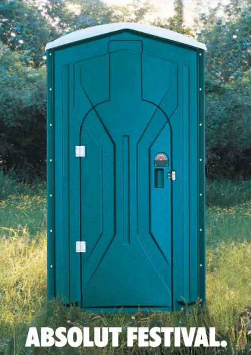 portable toilet outdoors with the caption absolute festival