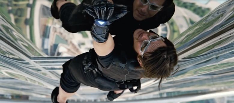 tom cruise climbing a building