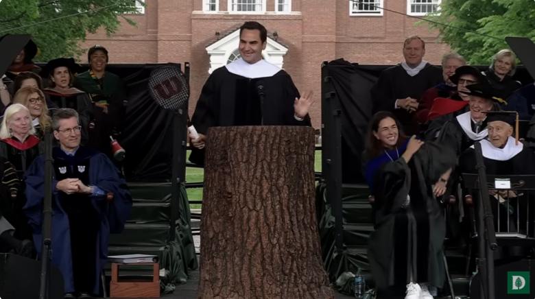 Roger Federer on a podium giving a speech