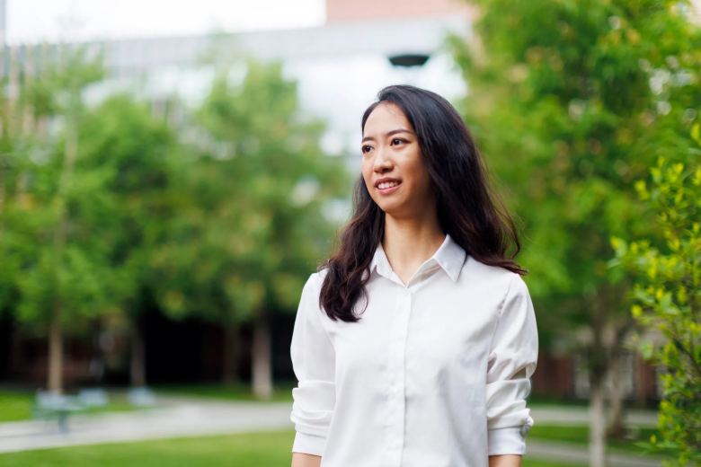 candid photo of yurong jiang walking on a campus