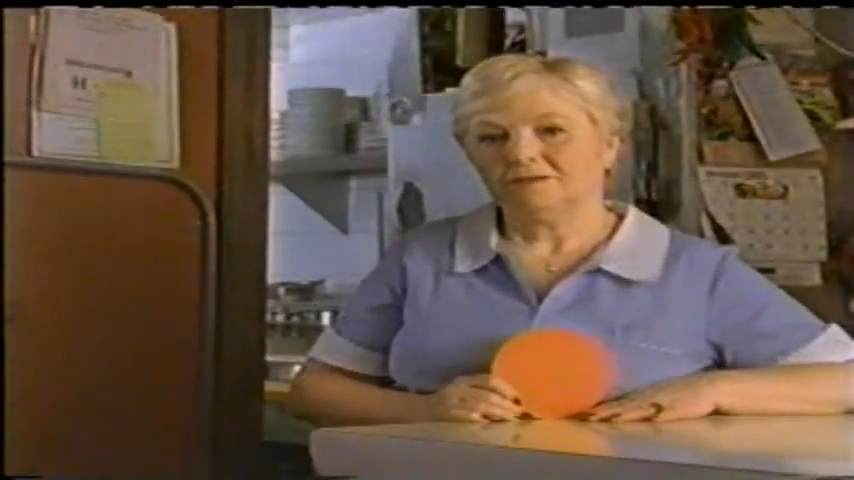 middle-aged woman as a waitress behind a counter