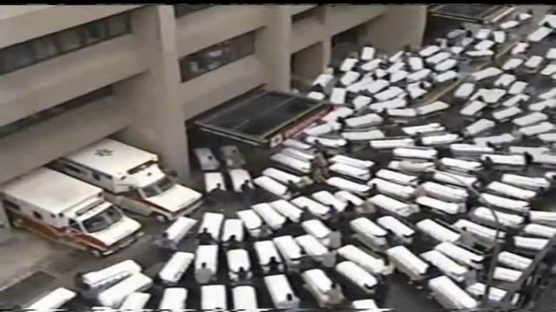 multiple hospital beds lined up at a hospital entrance