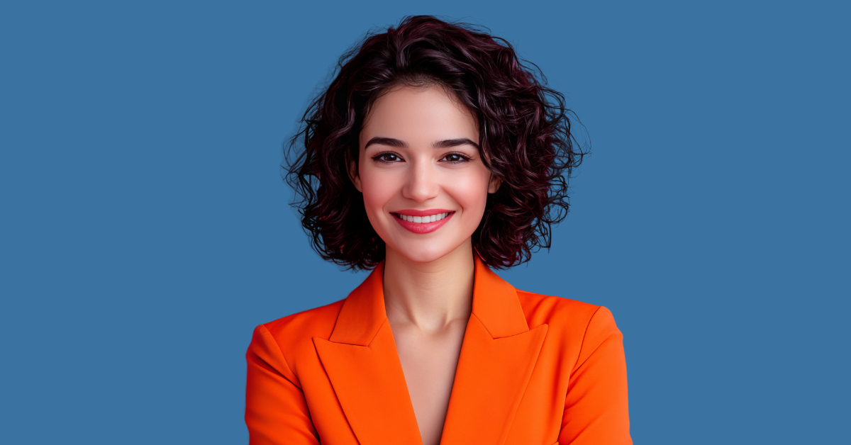 Confident woman in vibrant orange blazer with curly hair