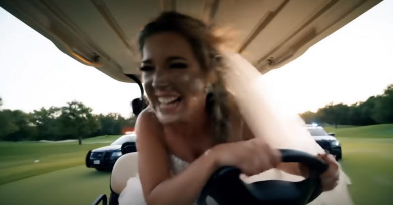bride joyfully driving a golf cart