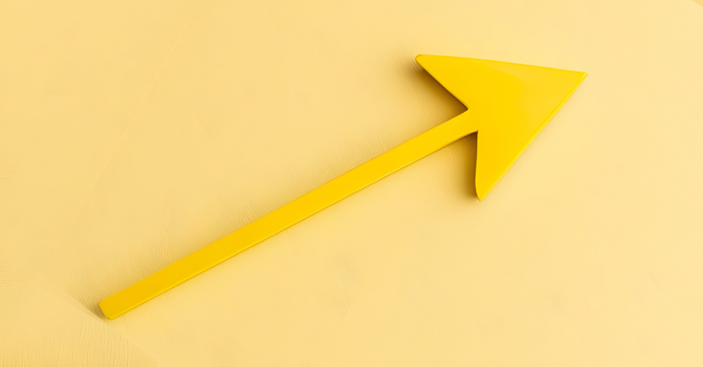 Yellow arrow pointing upward on matching yellow background