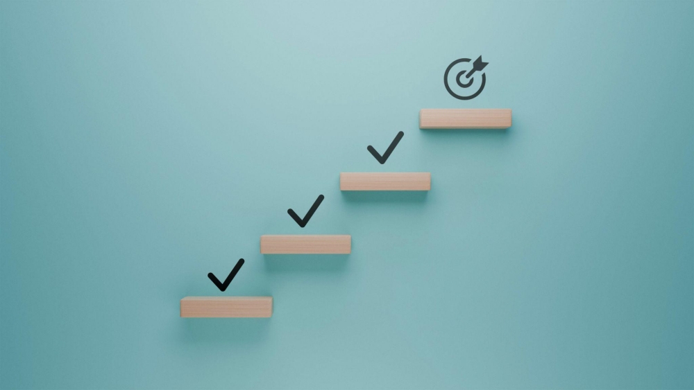 Steps with check marks leading to goal icon