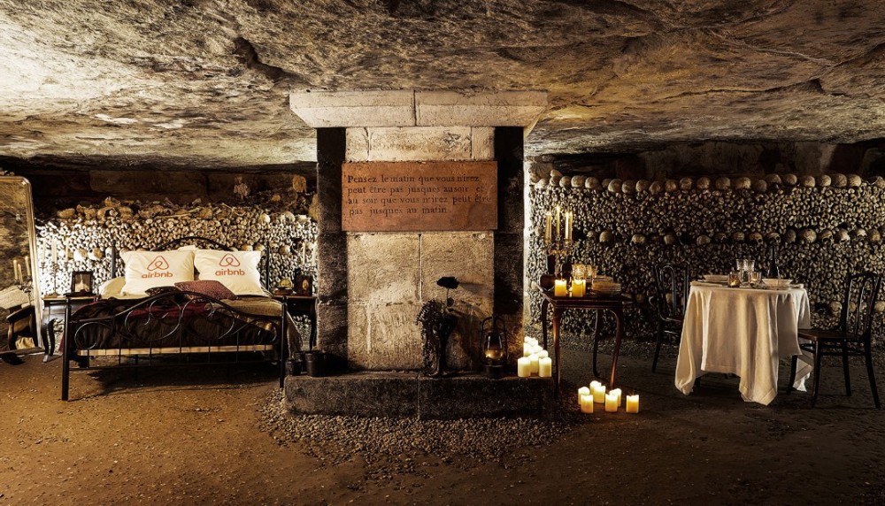 Airbnb bed in Paris catacombs with bones and candles
