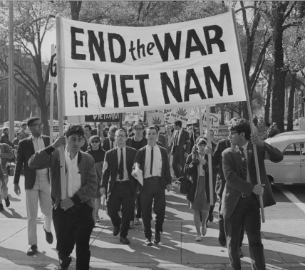 Protest march with a sign reading 'End the War in Viet Nam' held by a group