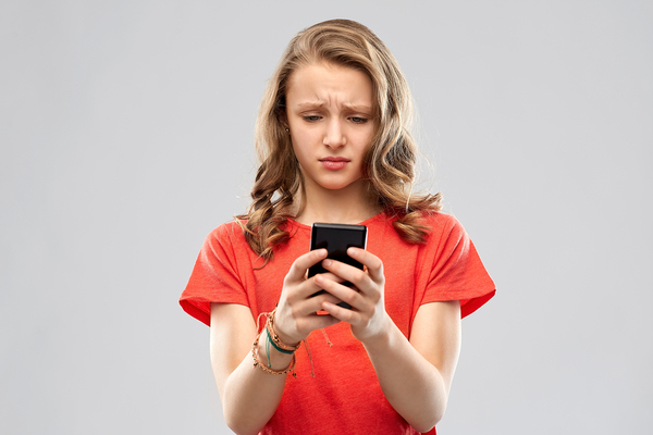 Young teen looking at her phone.