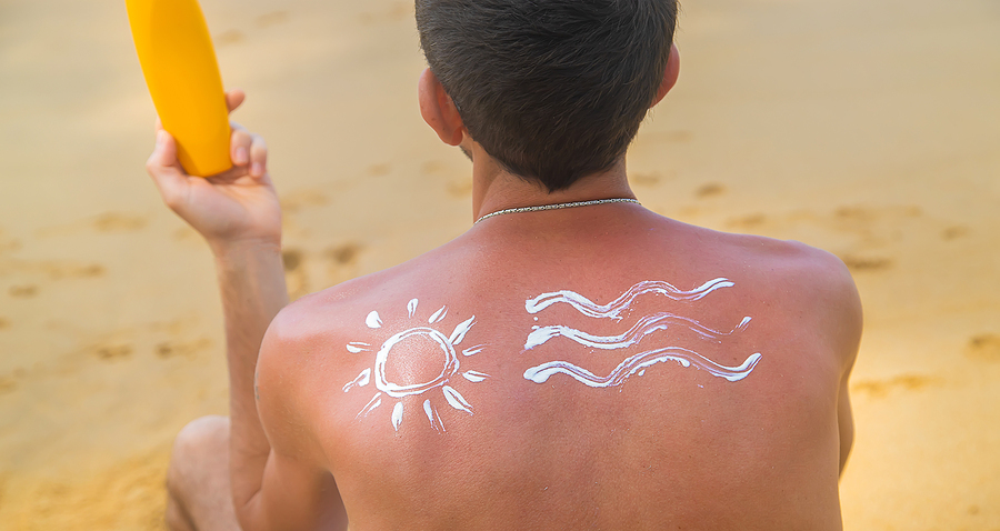 Man with a sun and waves on his back.