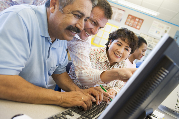Adult learners using desktop computers.