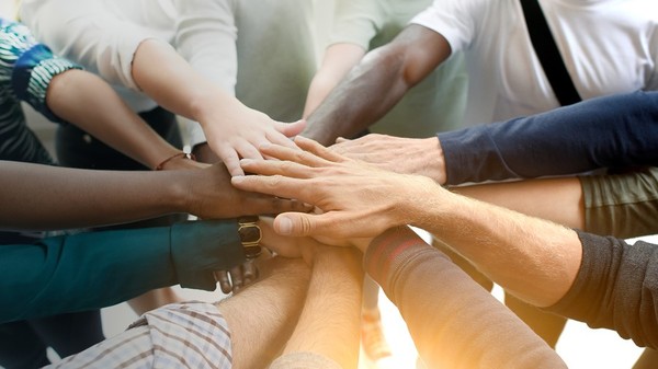 Innovative group making a circle with their hands.
