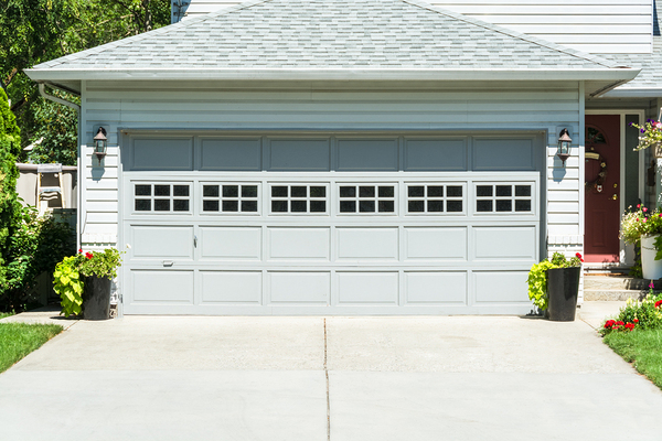 Double car garage with grey door.