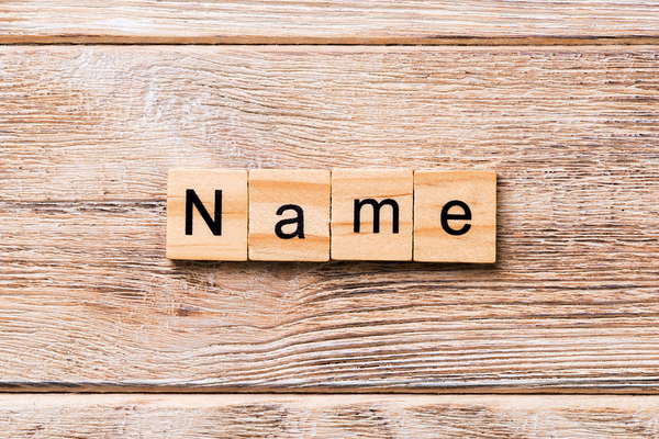 Name spelled out with wooden blocks.