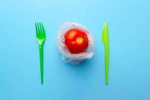 Tomato with fork and knife.