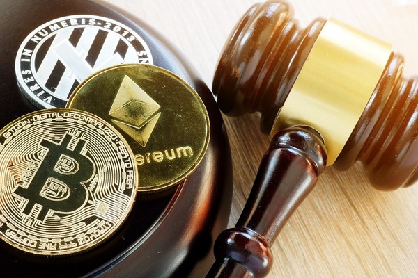 Gold bitcoin coins with a wooden gavel.