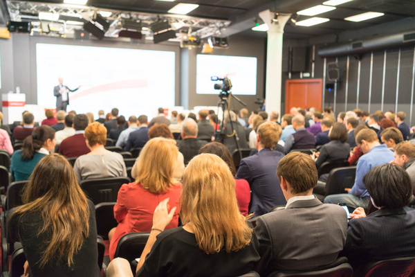 Speaker presenting to an audience.