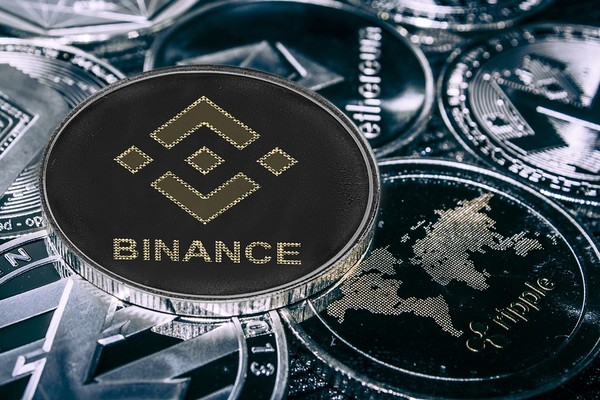 Silver coin with Binance logo.