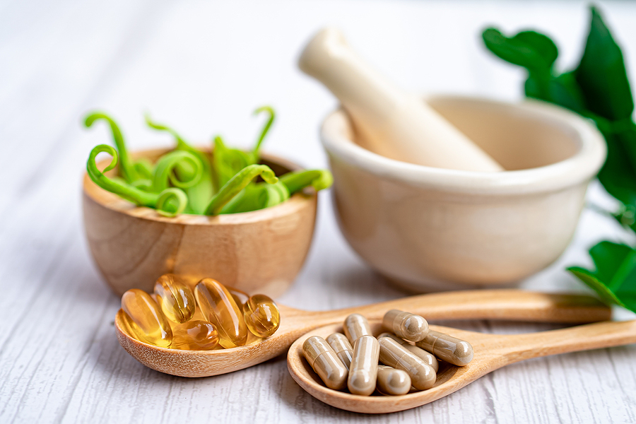 Vitamins in wooden spoons.
